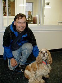 Upper Valley volunteer Tad Blackington and his newest clicker convert, Koko. Koko is confidently wearing a Gentle Leader, and waiting to hear a click for facing the camera.
